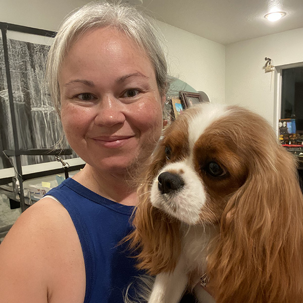 Dr. Bennett at home with Rosie, her brown-and-white spaniel